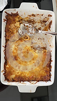 Half-eaten lasagna in a baking dish