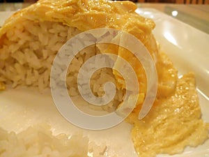 Half Eaten Plate of Omellete over Rice