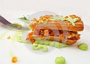 Half eaten sandwich sandwich with red caviar, pieces of salman and wasabi sauce. Process of eating