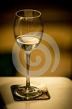 Half empty glass of white wine