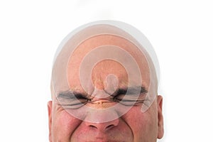 Half face of bald man in white background.