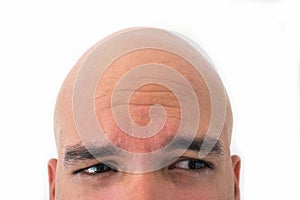 Half face of bald man in white background.