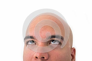 Half face of bald man in white background.