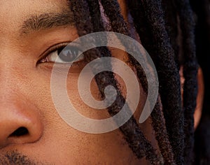 Half face portrait of african man with dreadlocks