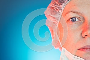Half face portrait of female medical professional with surgical