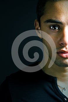 Half face portrait of one serious young man