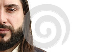 Half face portrait of a serious businessman with long hair and beard