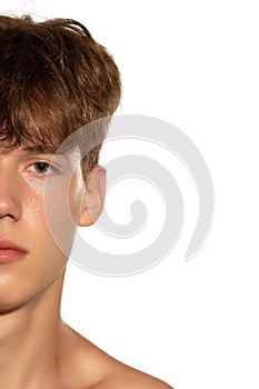 Half of face. Portrait of young handsome man isolated on white studio background. Concept of men& x27;s health, beauty