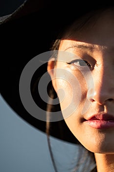 Half face portrait of a young oriental woman