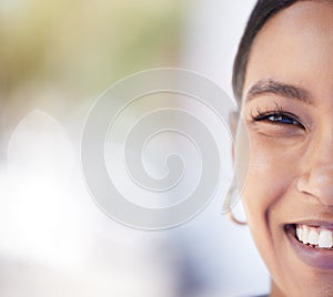 Half face portrait of a young woman with beautiful, smooth and clear skin with copy space. Closeup of a happy girl with