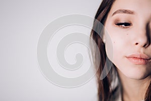 Half face of young beautiful woman. Plump lips and long eyelashes. The horizontal, copy space.