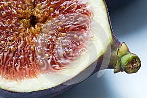Half fig, macro shot shows the juicy pulp with seeds