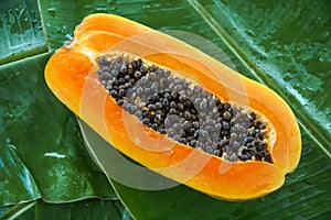 A Half of Fresh Raw Exotic Tropical Thai Fruit Carica Papaya on Banana Leaf