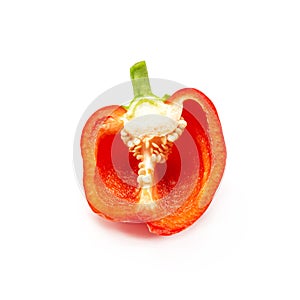 A half of fresh red bell pepper is on a white background