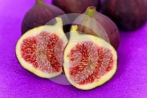 Half of the fruit of fig , on the purple backgroun