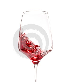 Half full of glass with red wine. Isolated on white. Close-up.