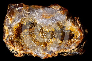 Half of a geode with quartz crystals colored yellow by iron oxides
