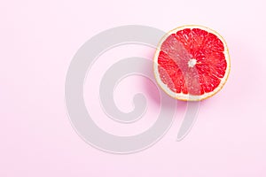 Half grapefruit citrus fruit on pink background