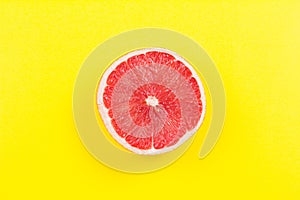 Half grapefruit citrus fruit on yellow background