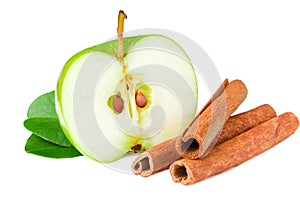 half of green apple with green leaves and cinnamon isolated on white background