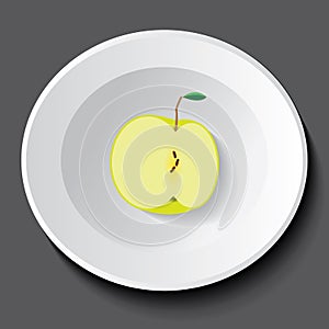 Half green apple in a plate