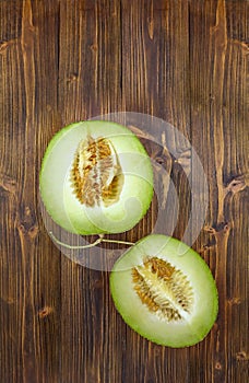 Half of green cantaloupe melon with seeds.