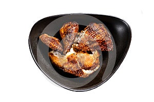 Half a grilled chicken on a plate. Isolated on white background. Top view.