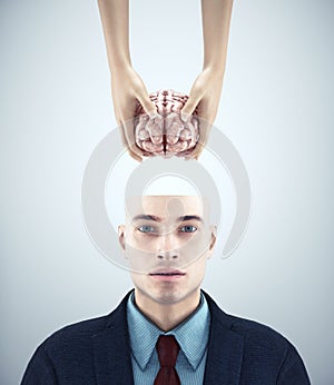 Half head man receiving a brain. Mental health and mindset change concept