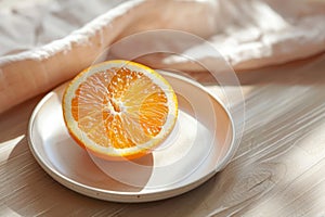 half of a juicy orange on a plate