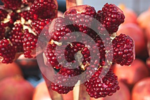 Half a juicy pomegranate closeup on a background of a counter in an open-air market