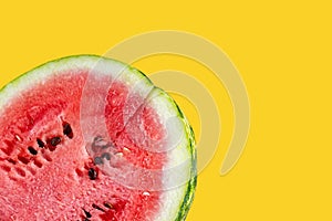 Half of a juicy watermelon on a yellou background. A piece of watermelon isolated on a yellou background. Ripe, juicy