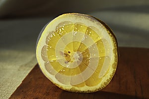 Half of lemon fruit at slice on the cutting board close up