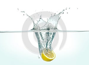 Half lemon splashing in water