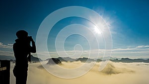 Half lenght of long hair photographer woman take photo of view in morning with sunrise on mountain