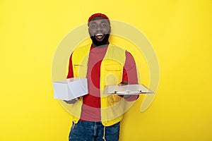 Half length of African man pulling clipboard and keeping delivery in arms