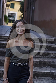 Half-length girl with curly brown hair.