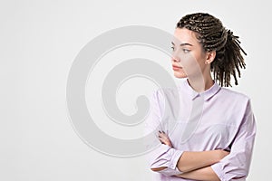 Half-length portrait of beautiful woman wearing white blouse looking aside.