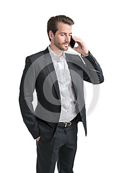 Half length portrait of businessman in formal suit talking on mobile phone holding his hand in pocket. Isolated on white