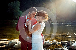 Half Length Portrait Charming Fashionable Newlywed Couple Hugging Countryside Landscape River Sunset Holding Hands