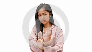 Half-length portrait of female gesturing rejection sign isolated in white background