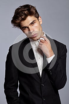 Half-length portrait of young handsome man in suit