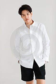 Half length shot portrait of a handsome good looking tomboy, a girl who loves to be a man, on white background