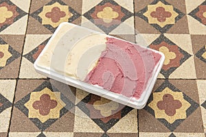 Half-liter tub of ice cream with two flavors in a home delivery container