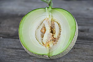 Half of melon on the wood background