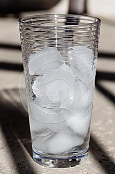 Half melted ice cubes in a clear glass