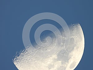 Half moon against blue sky