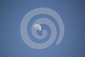 Half moon in the blue sky background