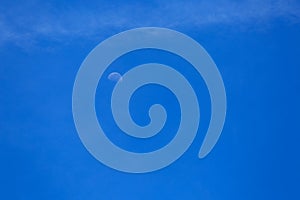 Half moon on blue sky and clouds