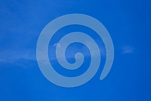 Half moon on blue sky and clouds