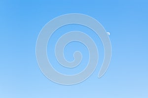 Half of moon in clear blue sky